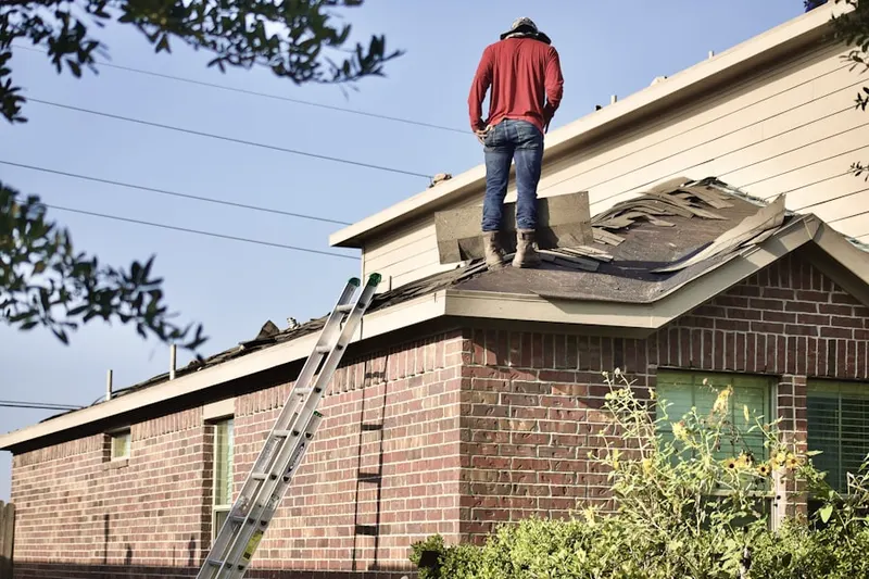 Professional roofer working on a residential roof in Norton Shores
